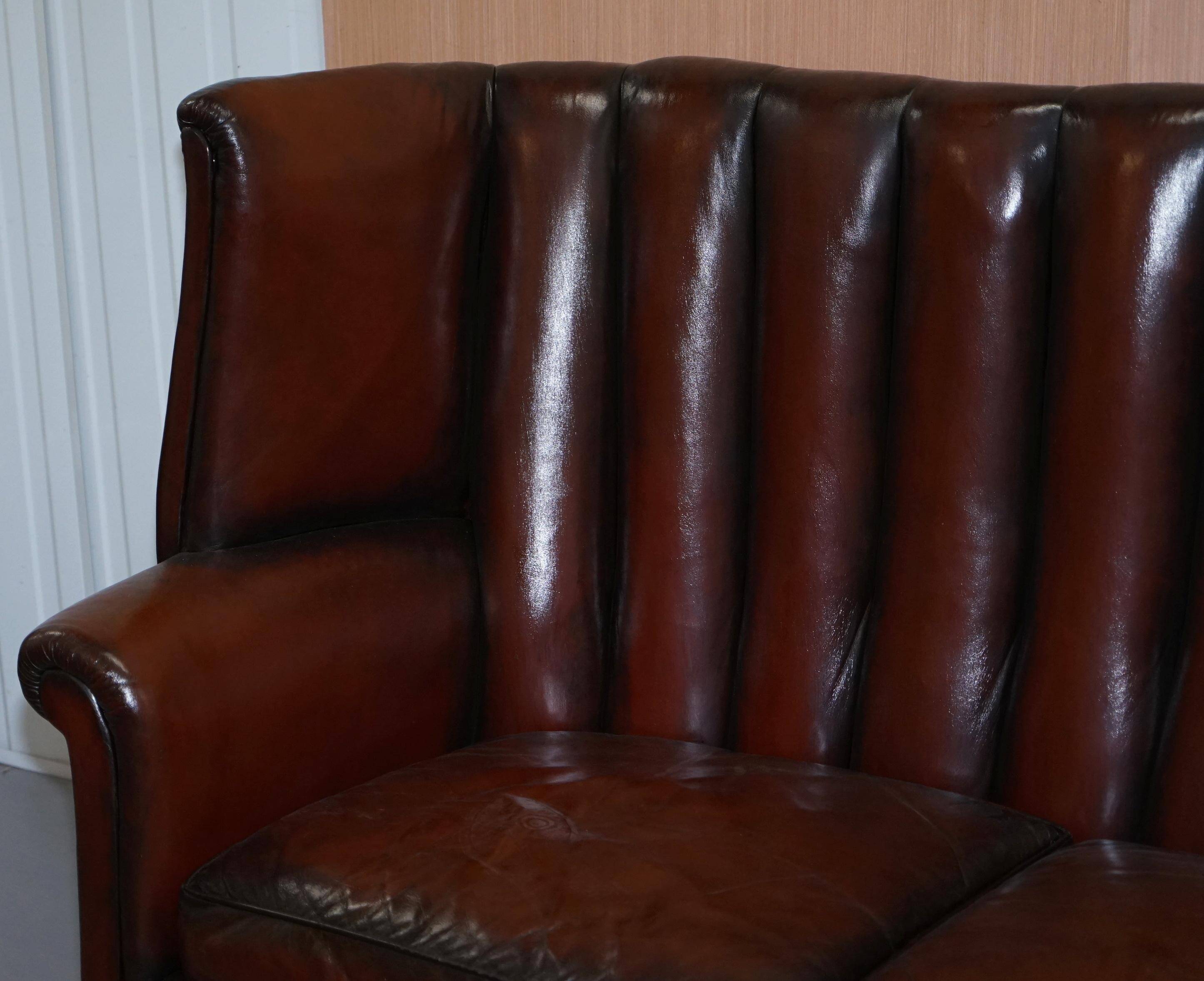 Victorian leather canapé and armchair, barrel back, circa 1860, restored.