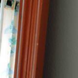 Beveled glass wall mirror in solid wood frame