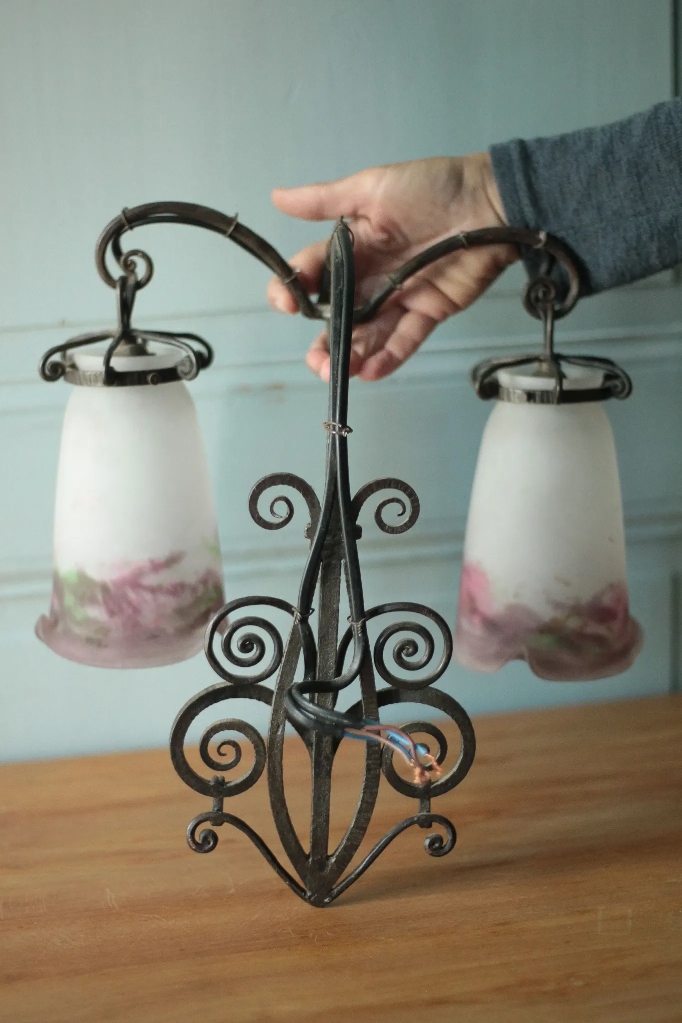 Wall lamp in wrought iron with a pink tulip glass globe by Muller glassworks.