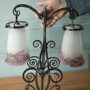 Wall lamp in wrought iron with a pink tulip glass globe by Muller glassworks.