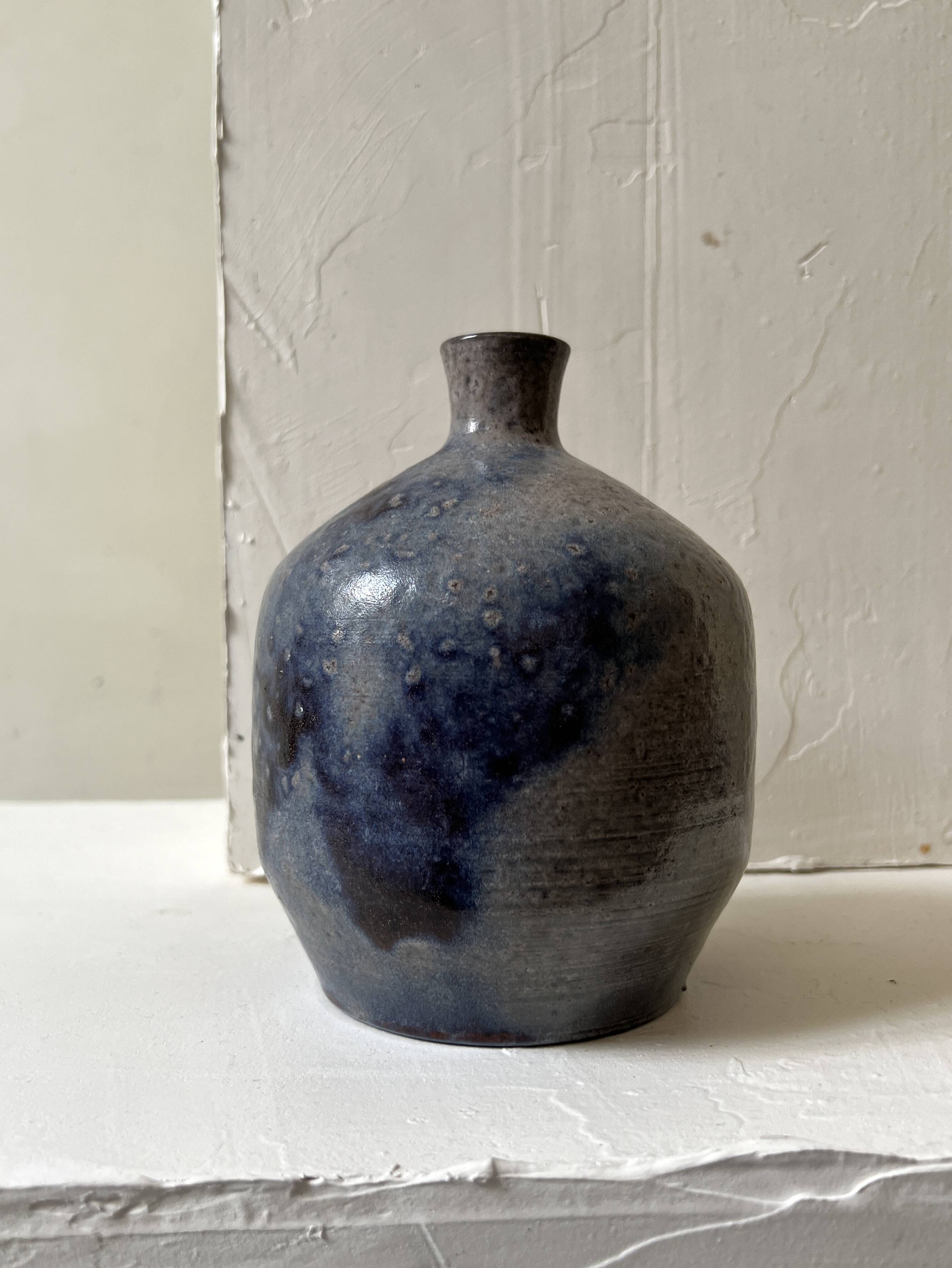 Glazed ceramic vase with a narrow neck and signed, unique piece.