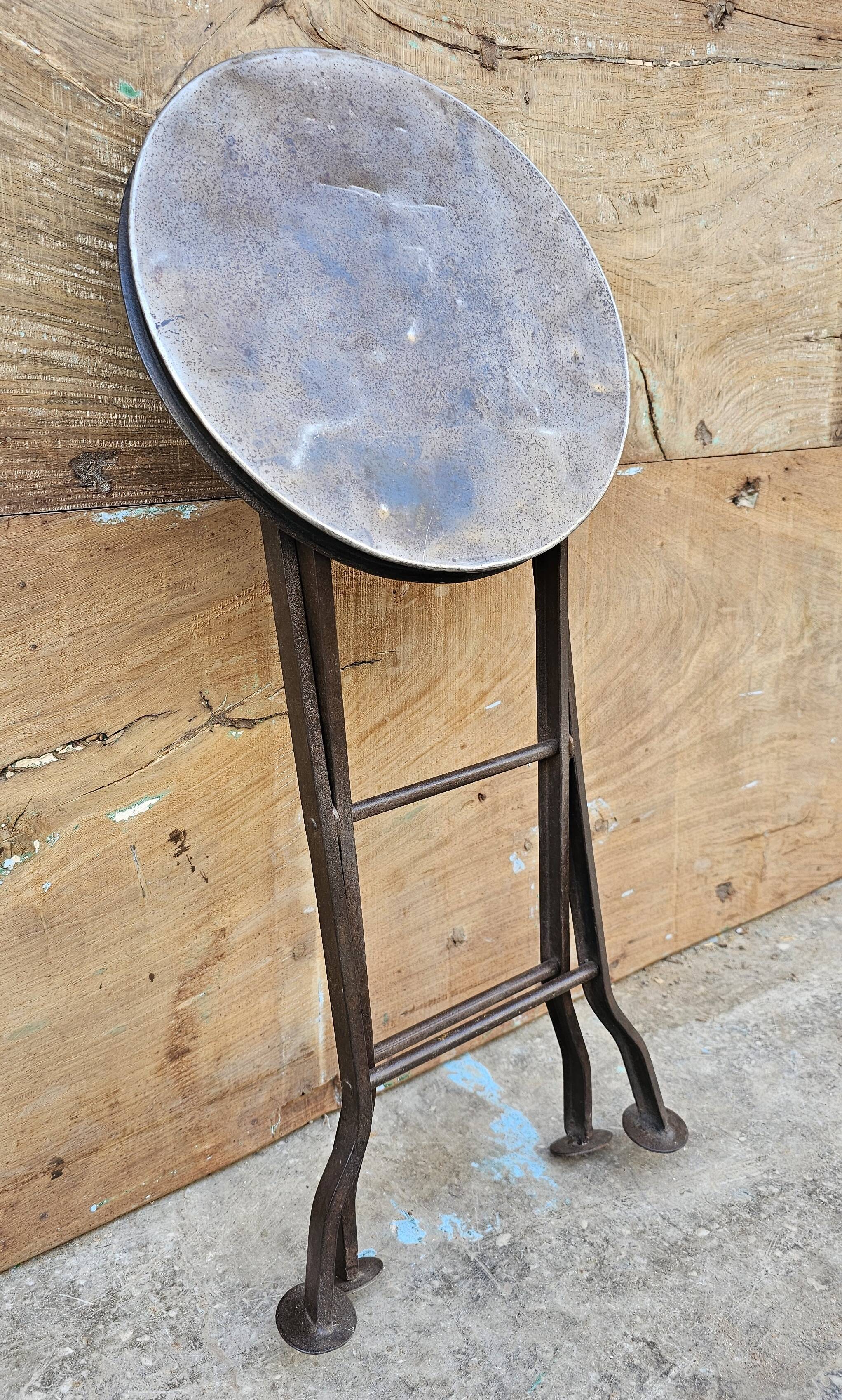 Old industrial folding steel stool