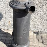 Poêle décoratif ancien en fonte noir Germare charbon bois