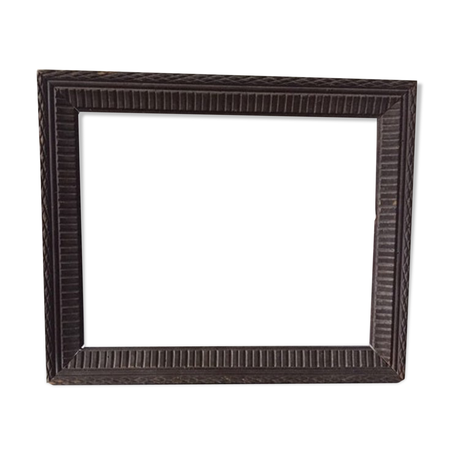 Antique wooden frame with geometric carvings light distress