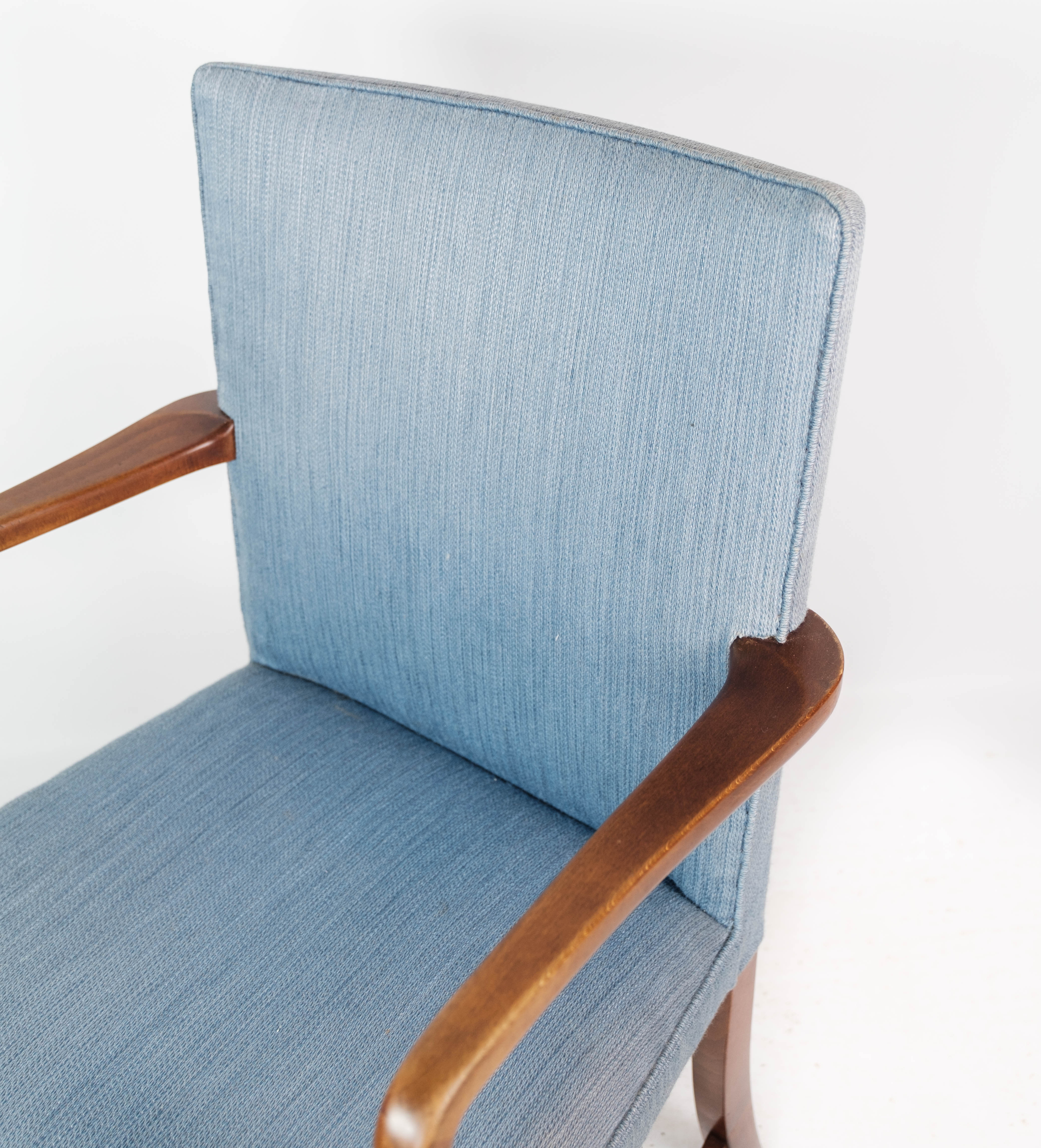 Armchair in mahogany and upholstered with light blue fabric by Fritz Hansen