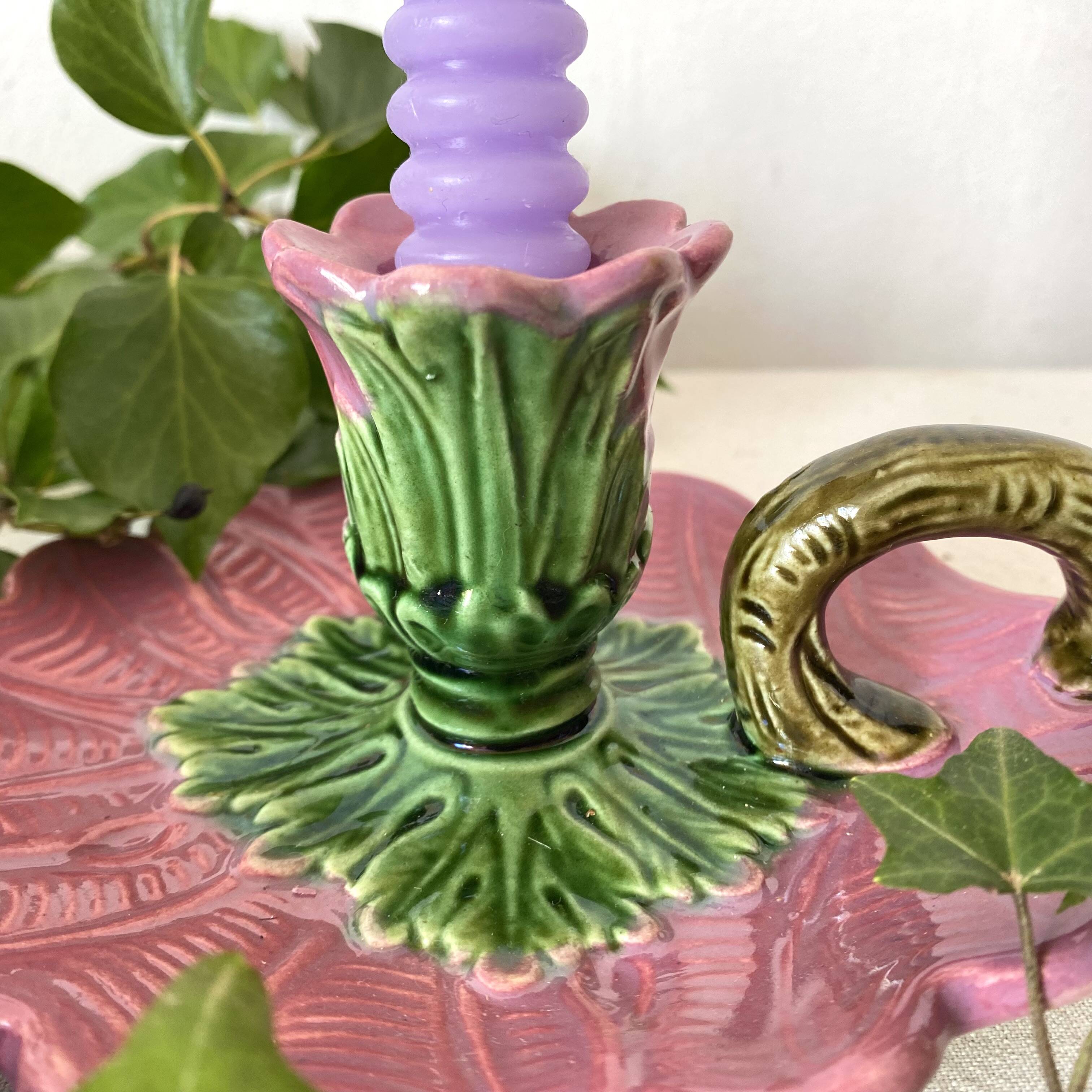 Antique slip candlestick depicting a flower