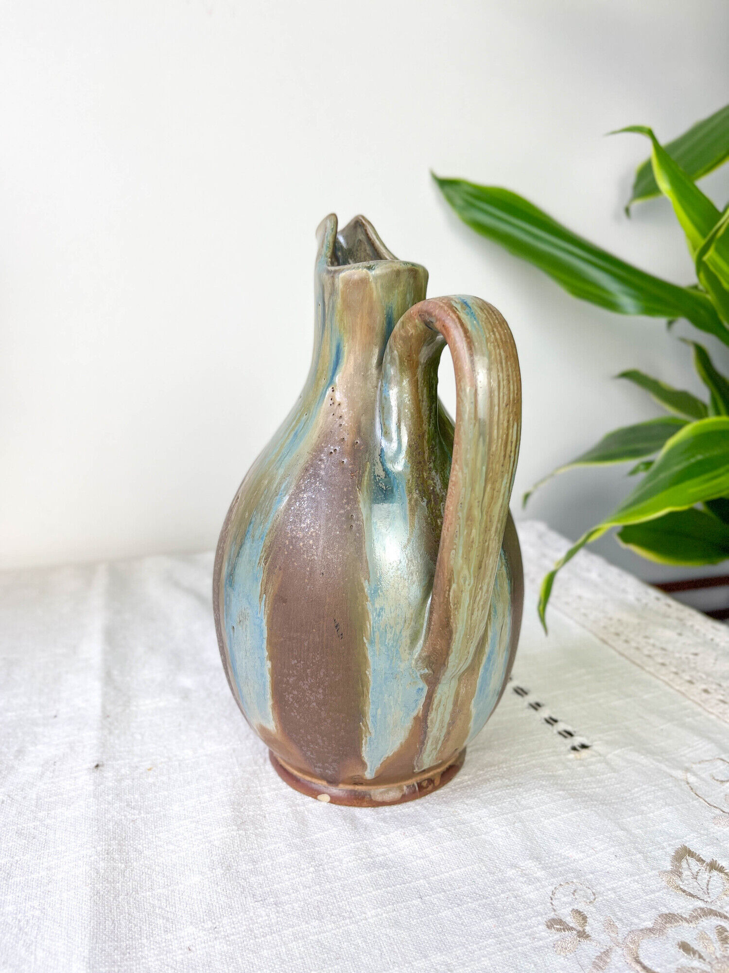 Art Nouveau style carafe in flamed stoneware with blue and brown drips