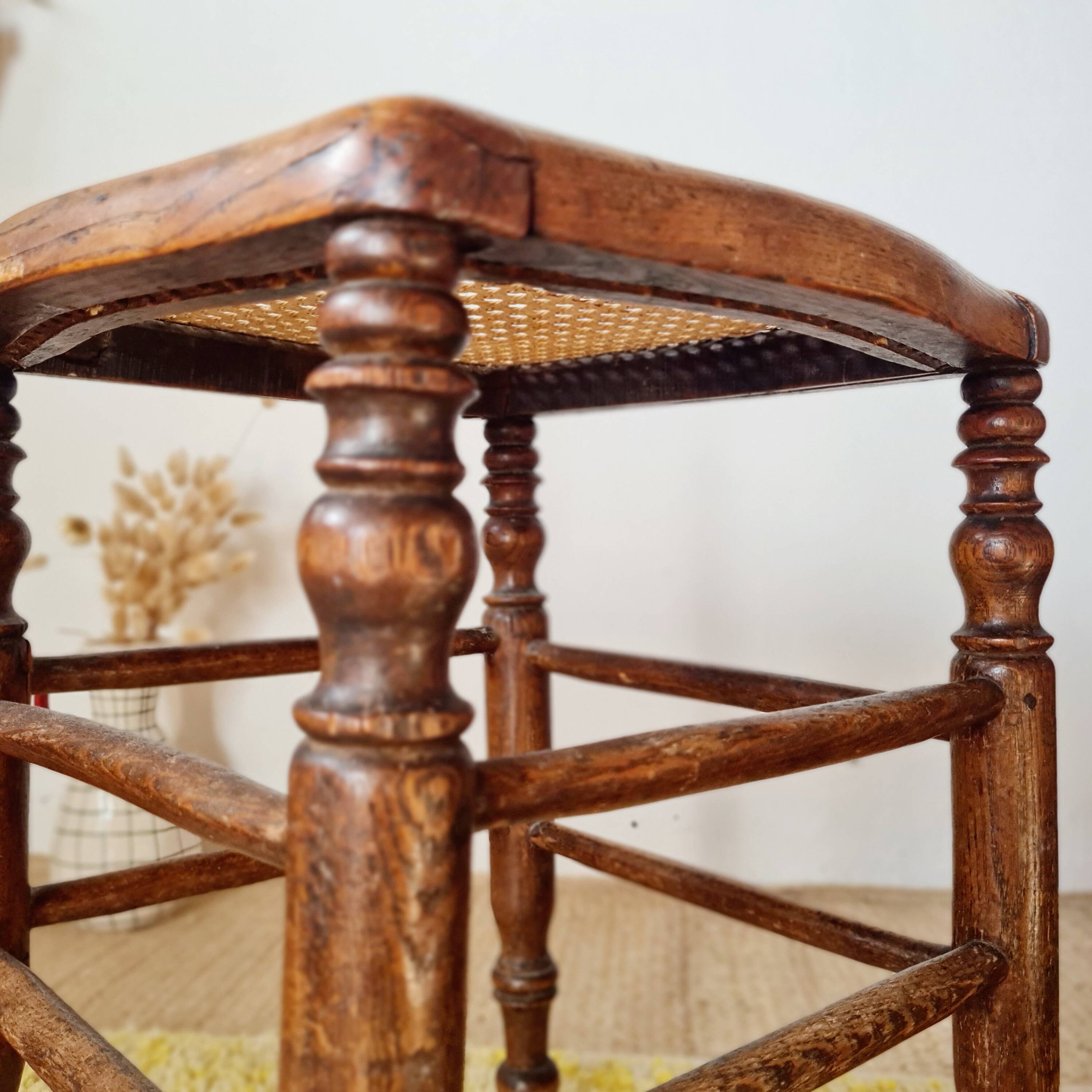 Wooden stool with cane seat