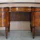 Regency style hardwood and leather kidney desk with gallery.