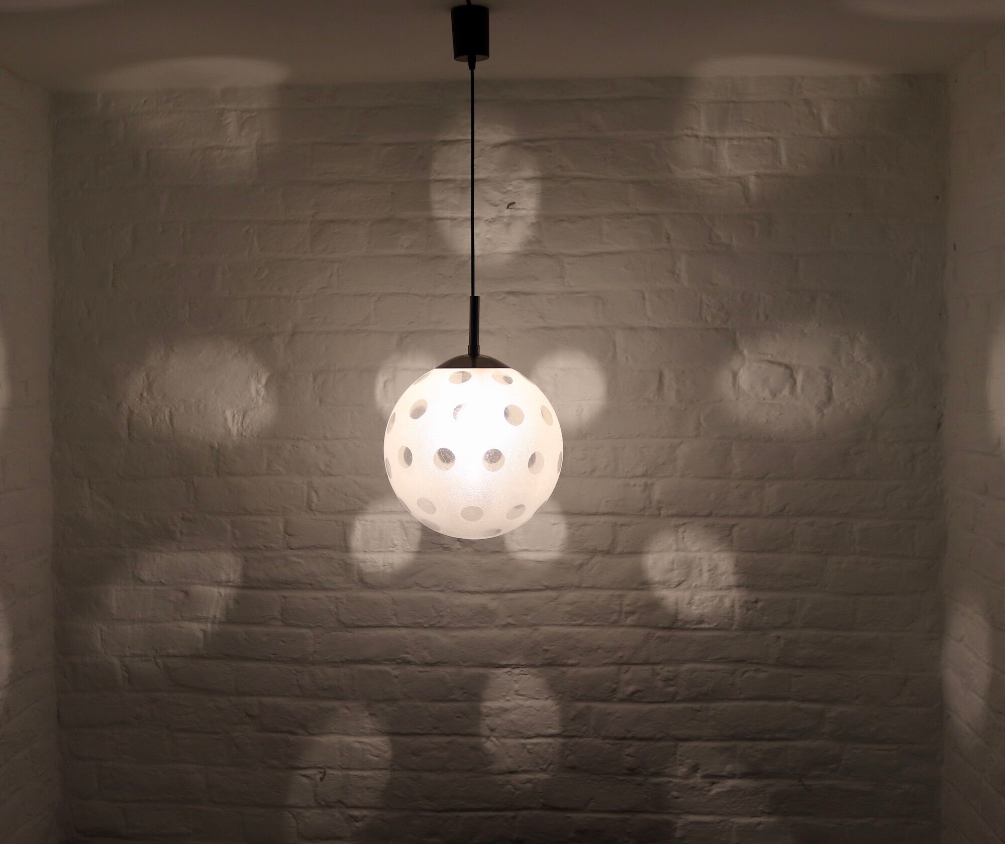 Curtained glass globe suspension