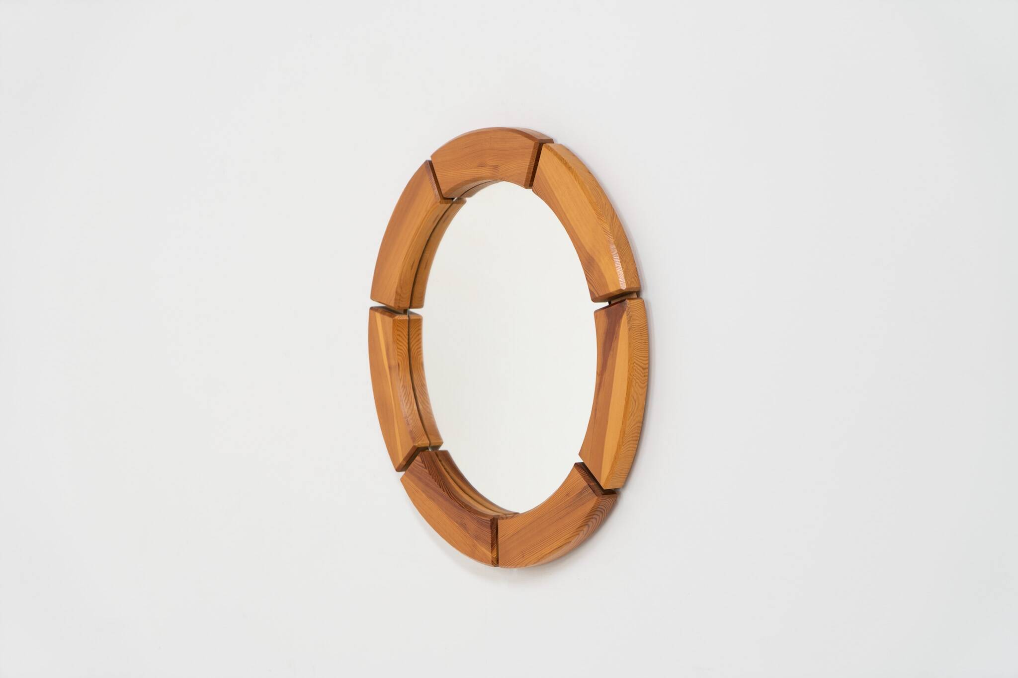 Sculptural wall mirror in solid pine