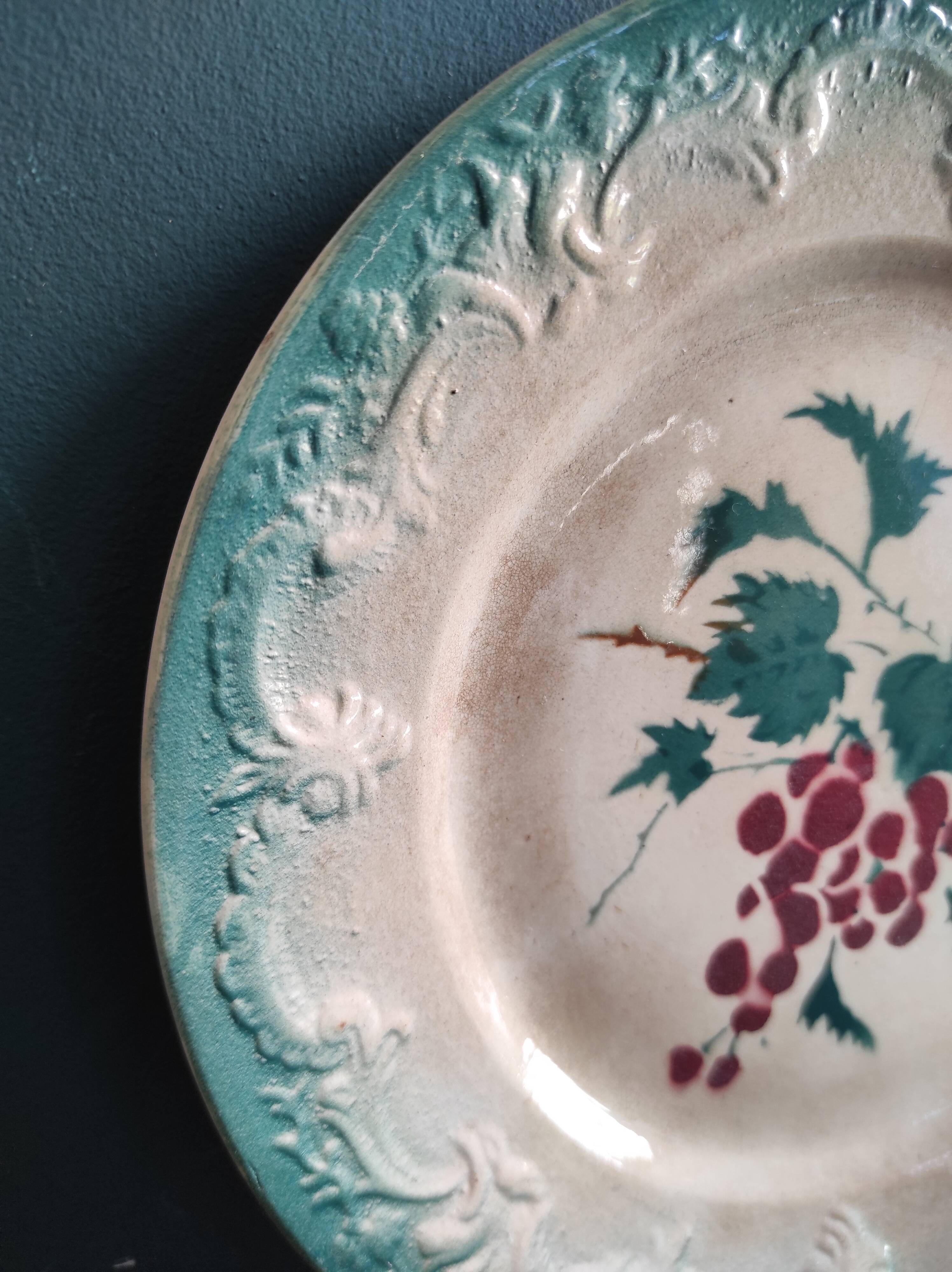 French antique barbotine plate decorated with stencil of grapes, faience de Castres