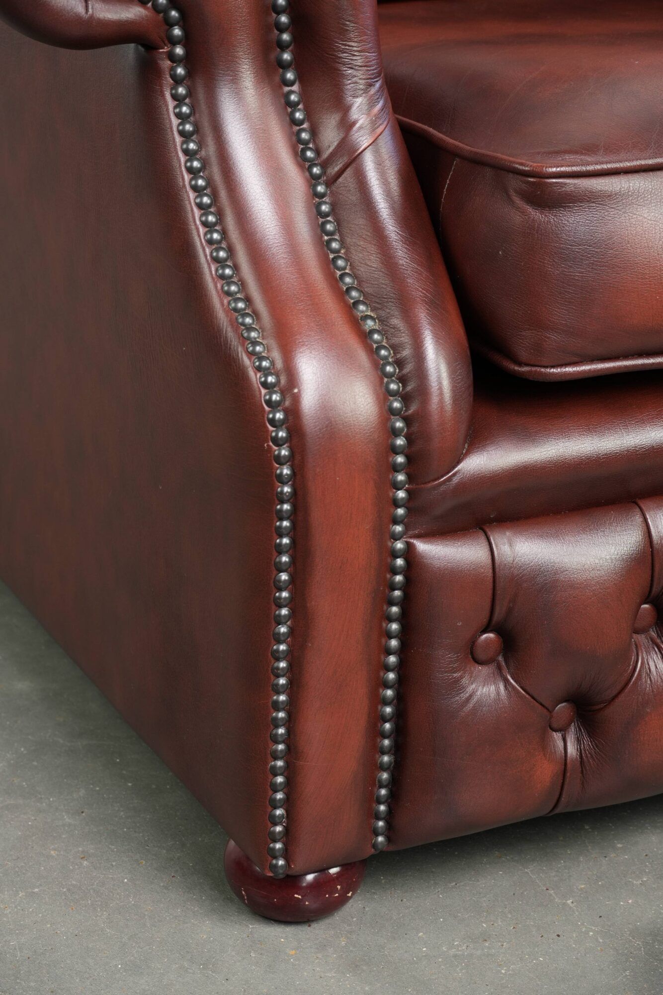 Cowhide chesterfield armchair in a warm brown colour with decorative nails