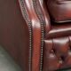 Cowhide chesterfield armchair in a warm brown colour with decorative nails