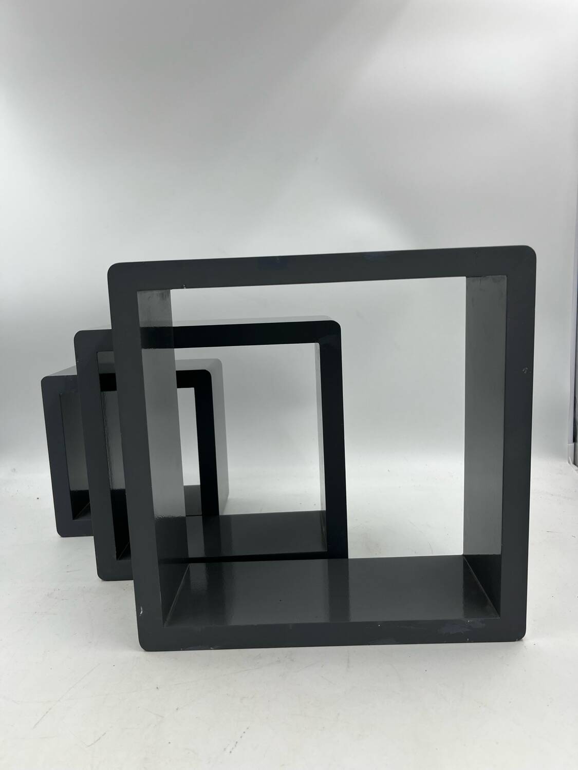 3 nesting shelves in grey lacquer.