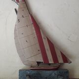 Wooden and metal hook in the shape of a sailboat