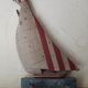 Wooden and metal hook in the shape of a sailboat