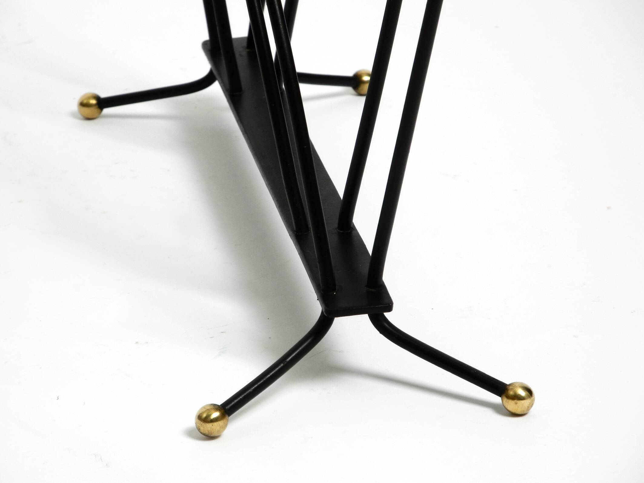 Mid Century newspaper and magazine stand made of iron with brass details