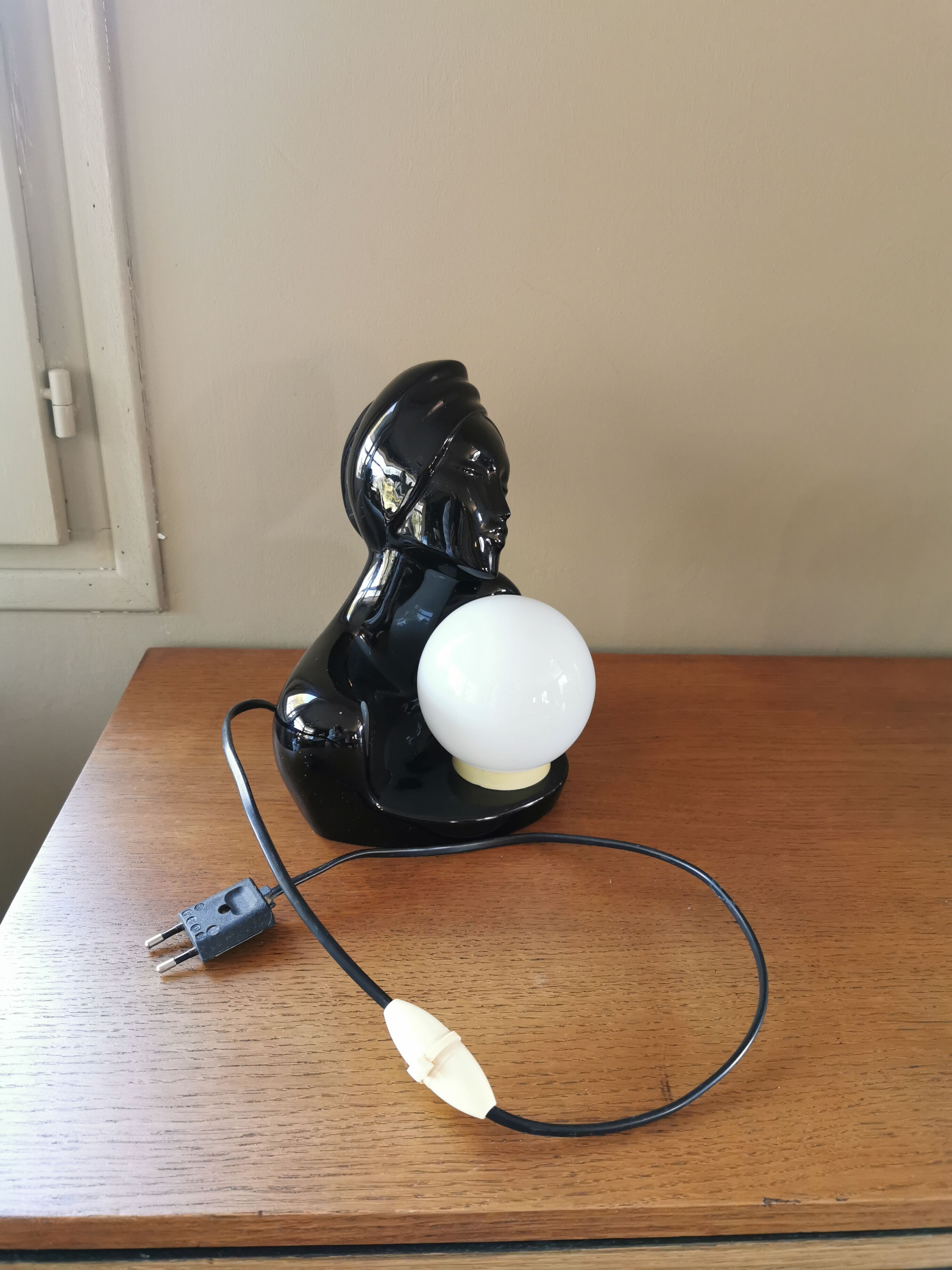 Vintage 80s lamp in the shape of a woman's bust made of black ceramic.