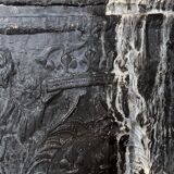 huge old fireplace plate has decoration of angels, crown and fleurs-de-lis