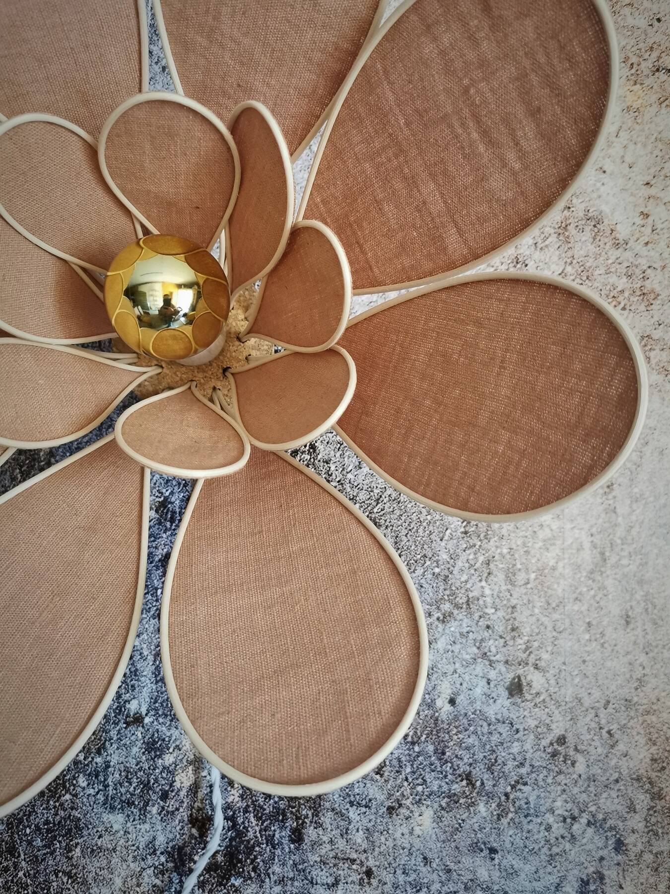 Flower wall light made of rattan and nude linen petals