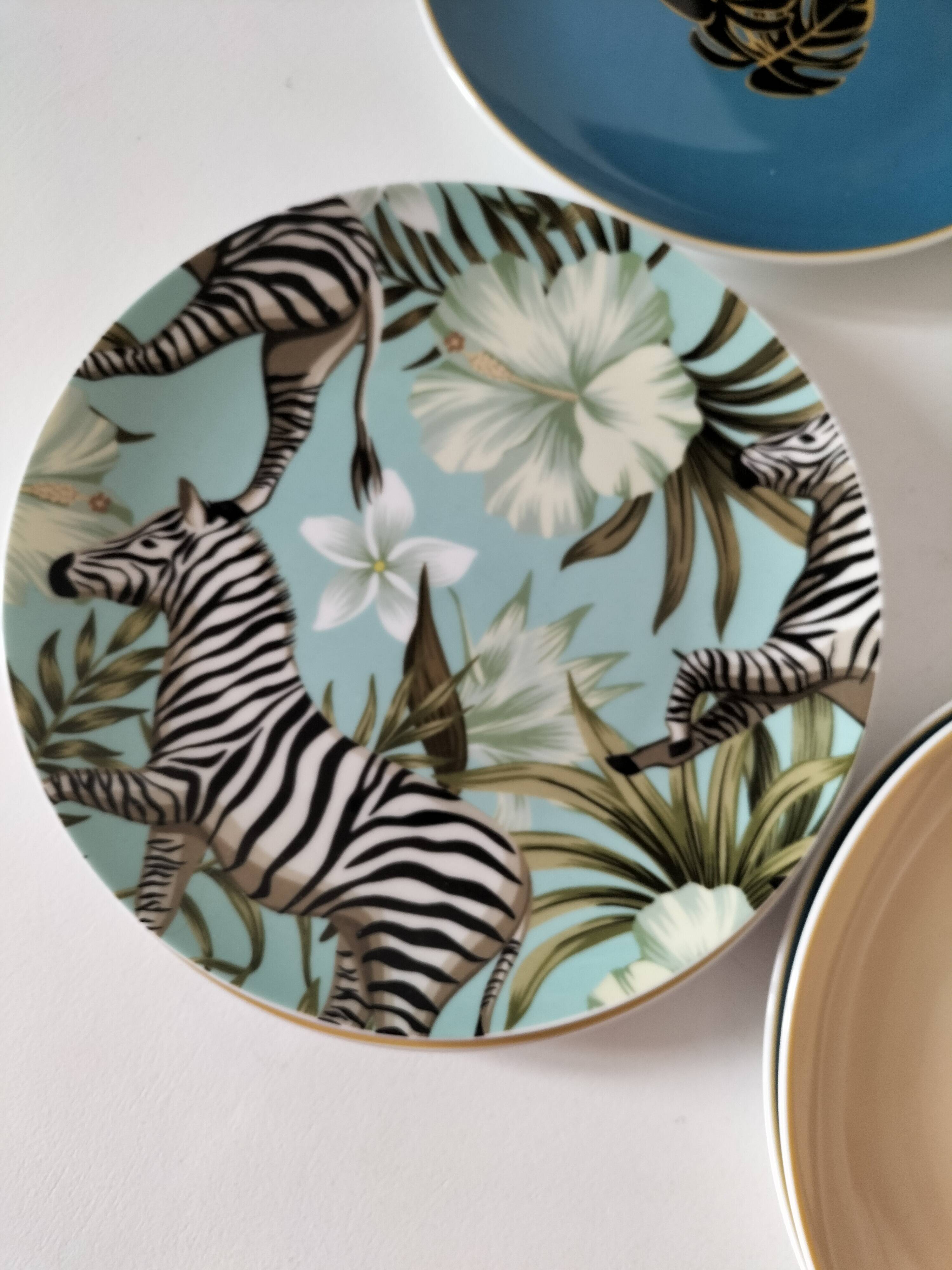 Set of 7 porcelain plates, gold foliage & jungle