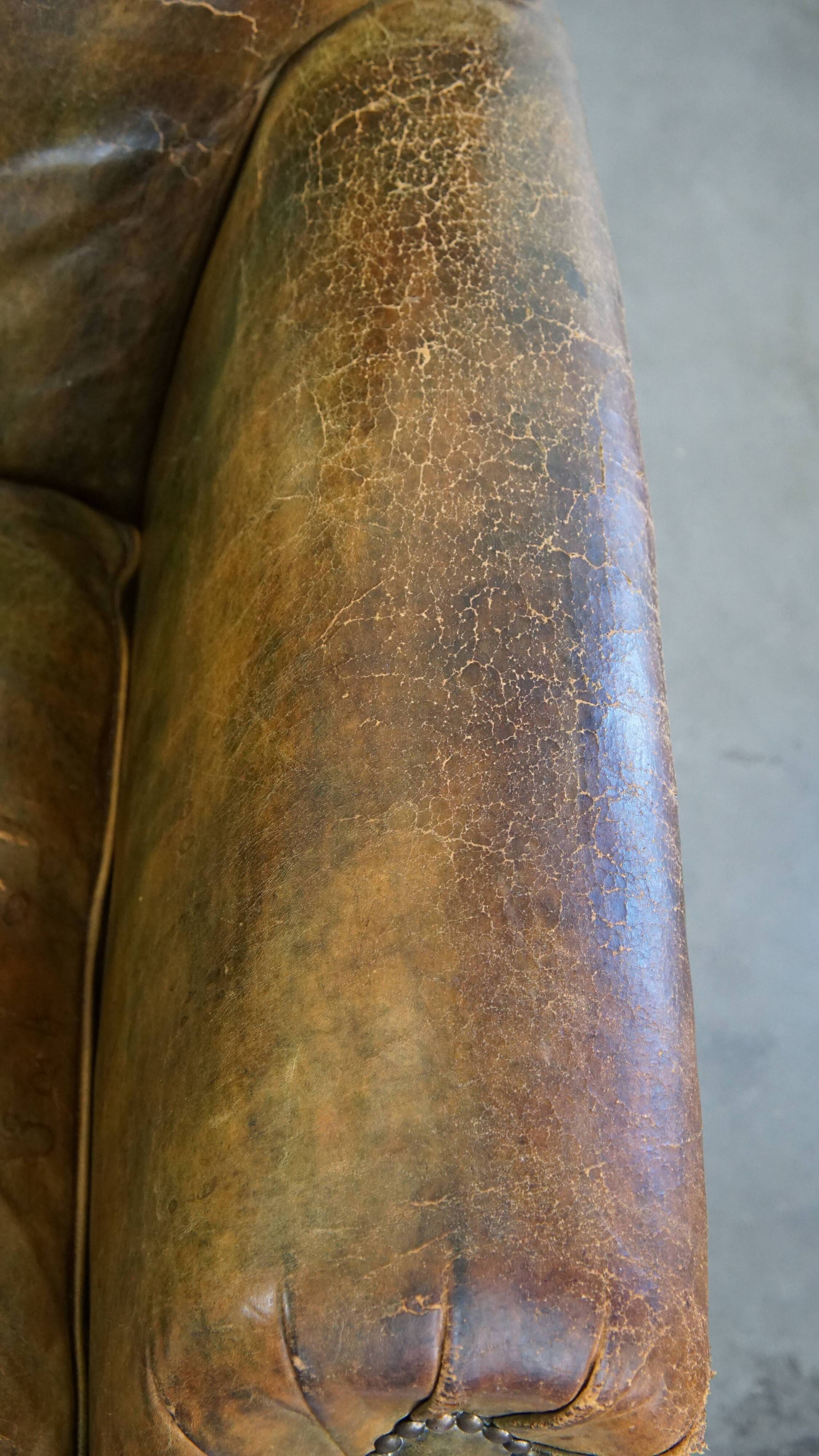 Green antique English cowhide leather armchair on wheels