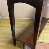 Mahogany console with a golden border.