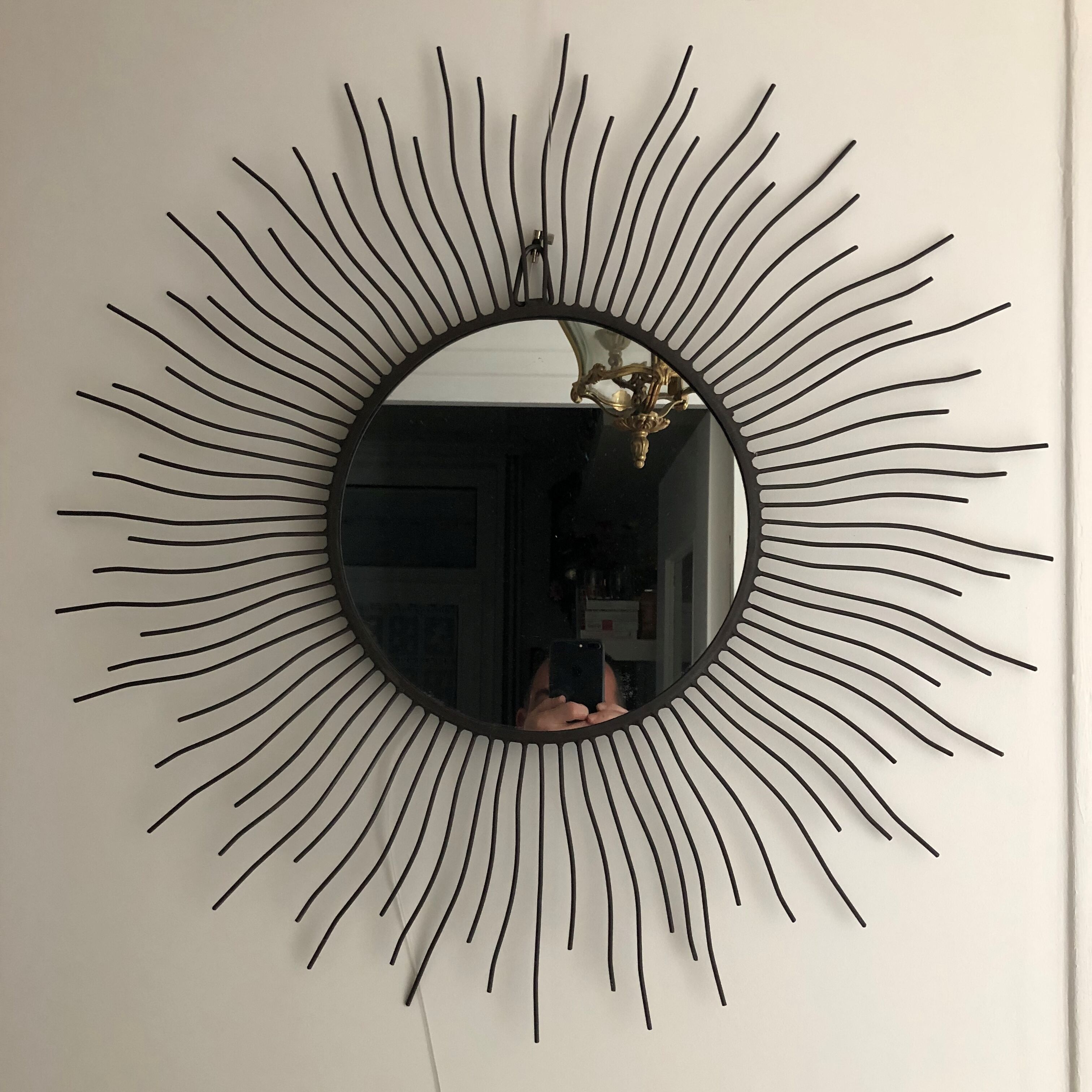 Sun mirror in black lacquered metal