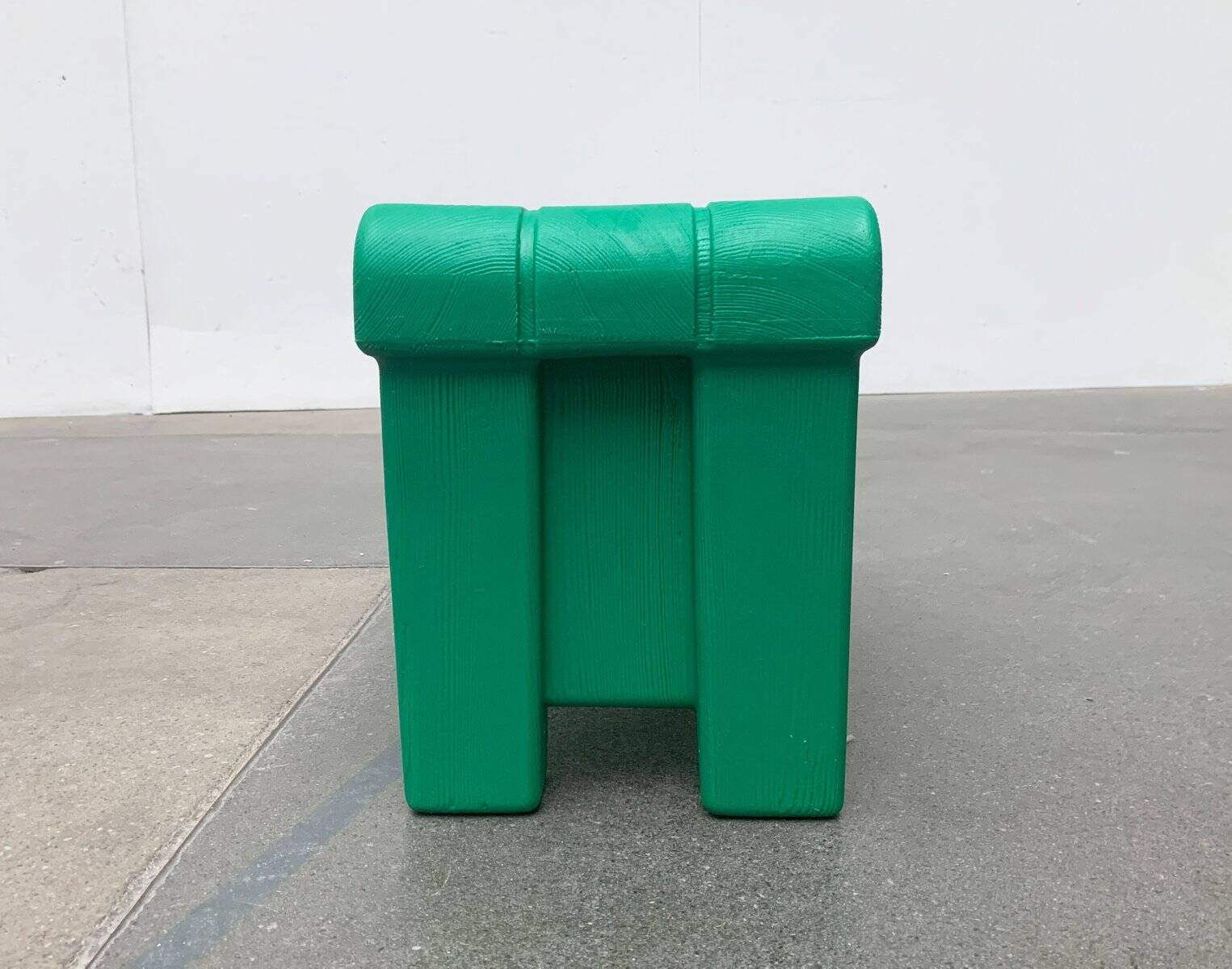 Postmodern plastic stool with a wood effect.
