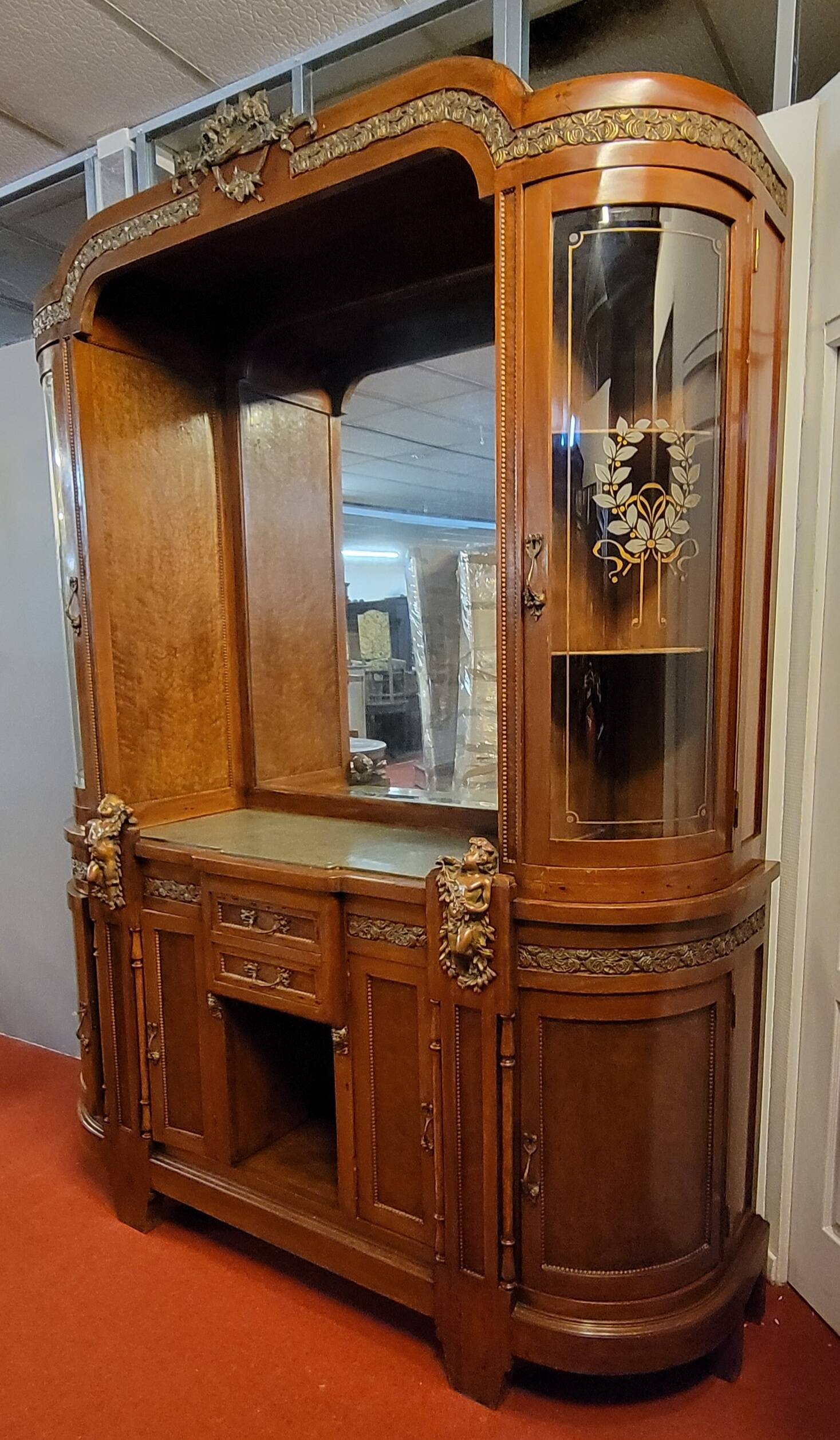 Empire style half-moon shaped mahogany bookcase with putti