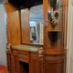 Empire style half-moon shaped mahogany bookcase with putti