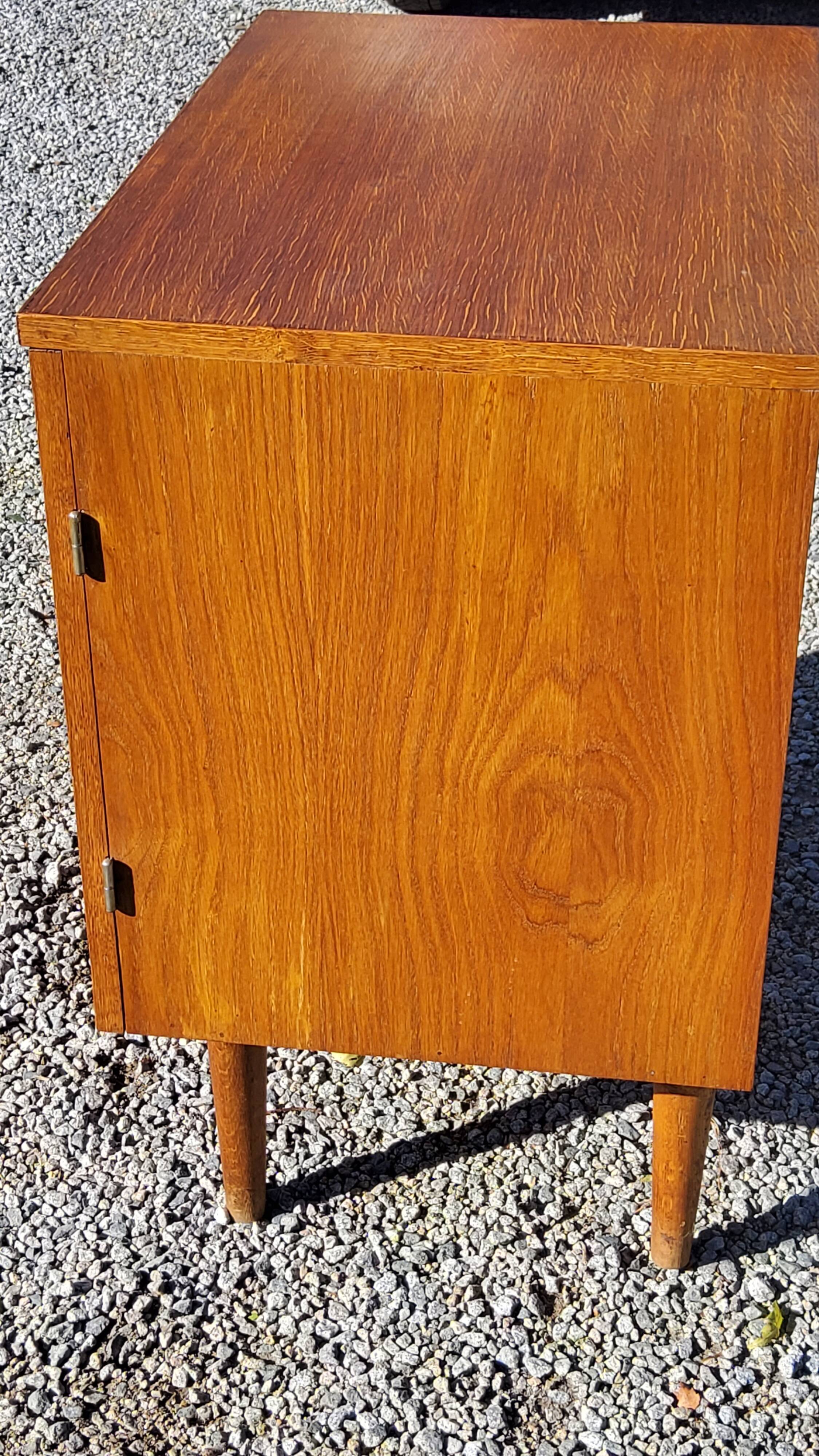 Vintage golden oak sideboard with conical legs from the 1950s