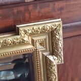 Antique mirror in wood and gilded stucco, neo Louis XVI style.