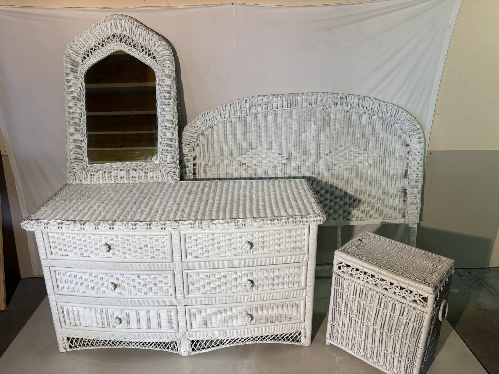 White rattan bedroom set: chest of drawers, mirror, bed, basket