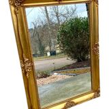 19th century style gilded wooden beveled mirror with ornate corners