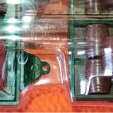 Mercedes flatbed containing drums pulling 1 trailer carrying 1 covered vehicle