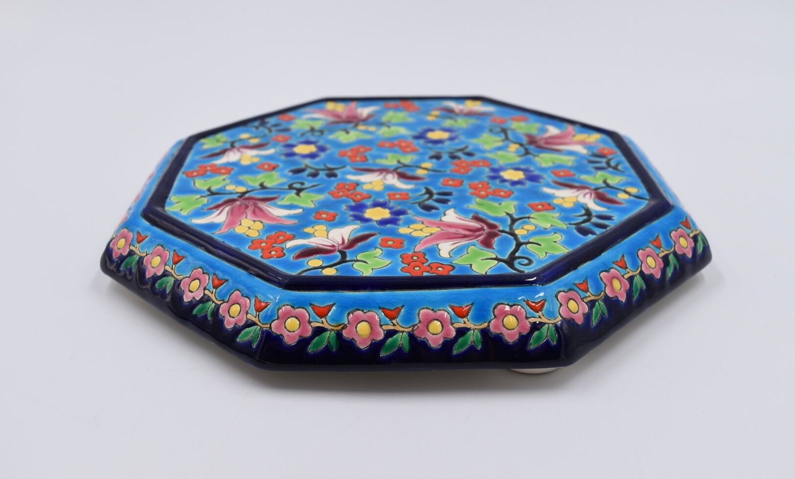 A flat bottom and two enamel bottle bottoms of Longwy