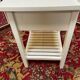 Wooden bedside table painted white