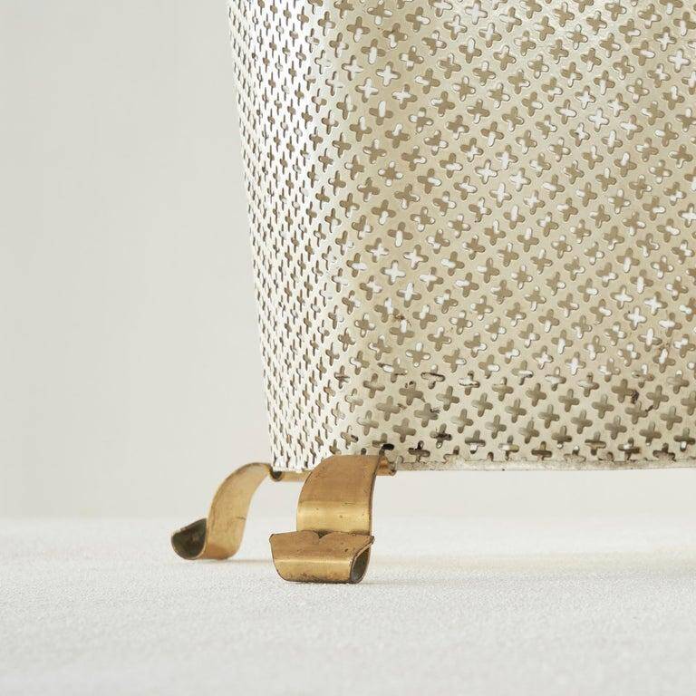 Mid-century umbrella stand in patinated brass and perforated metal, 1950s.