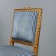Chairs and antique armchairs in neoclassical style from the 19th century.