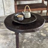 Small antique Indonesian bench in carved teak with plant and floral motifs.