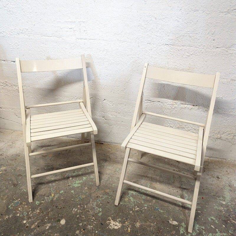 Pair of white wooden folding chairs