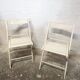 Pair of white wooden folding chairs