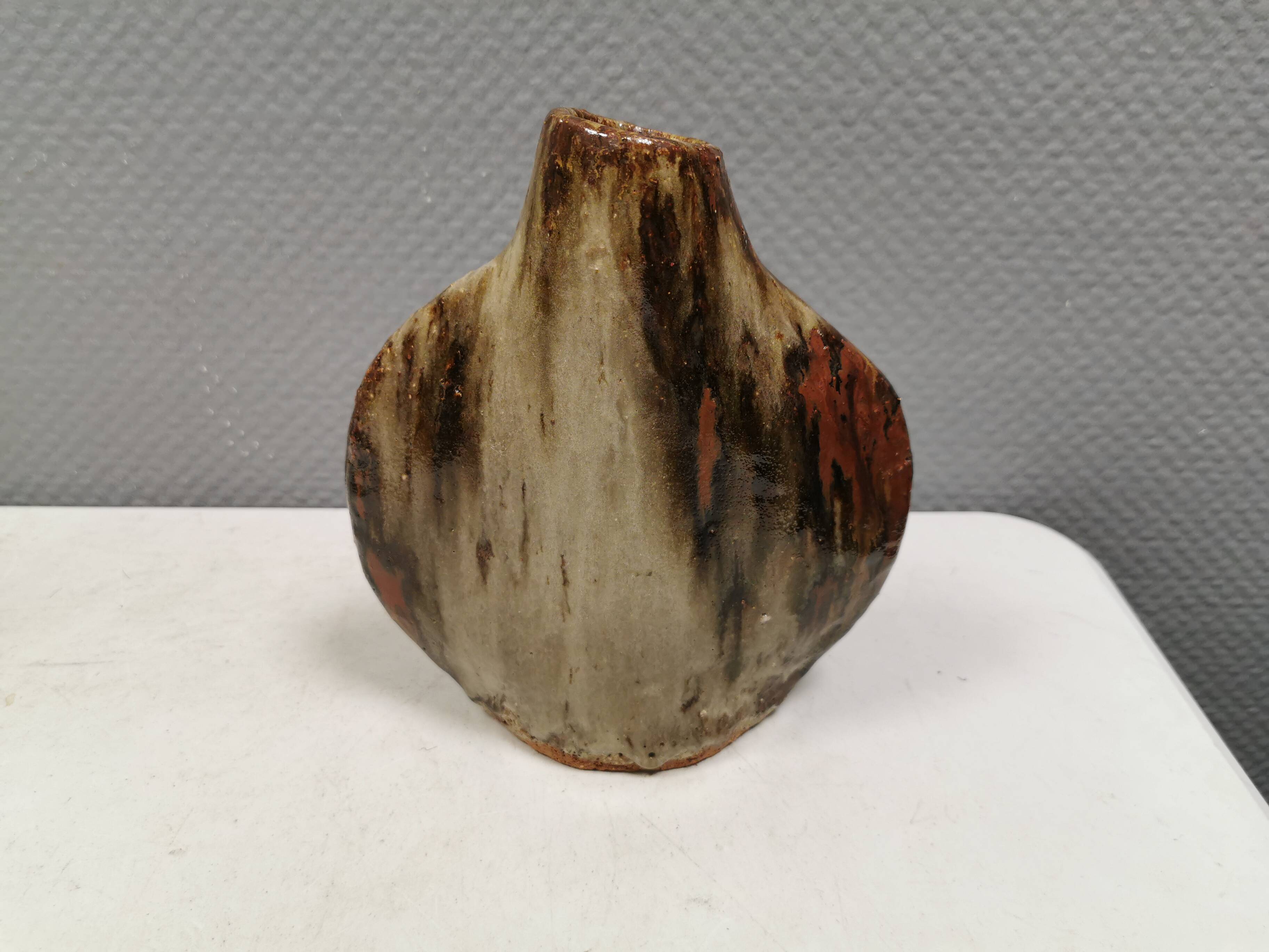 A beautiful Brutalist vase in lovely earth tones. Danish, from the 1980s.