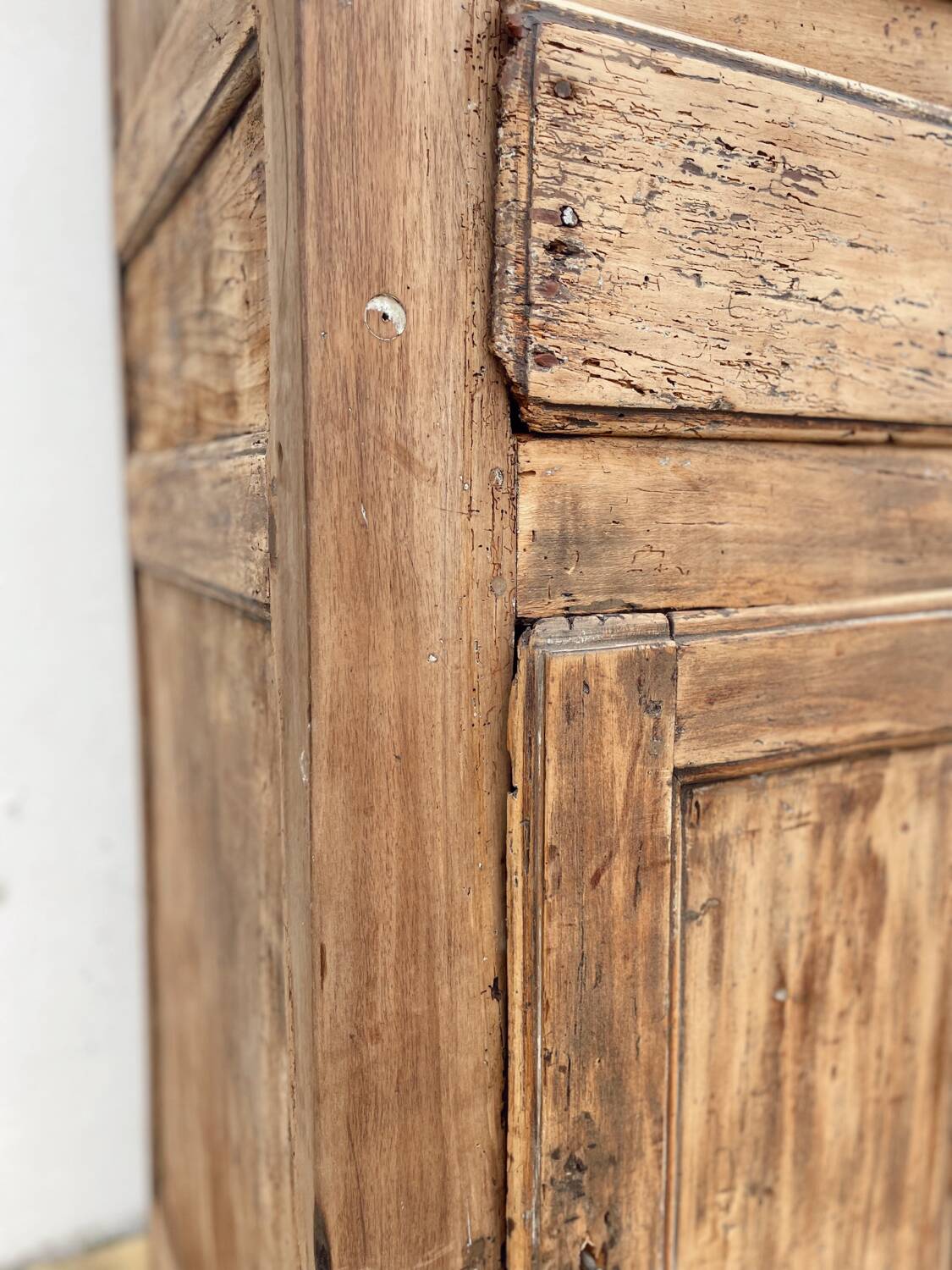 Rustic and vintage wardrobe in raw wood, wabi-sabi style.
