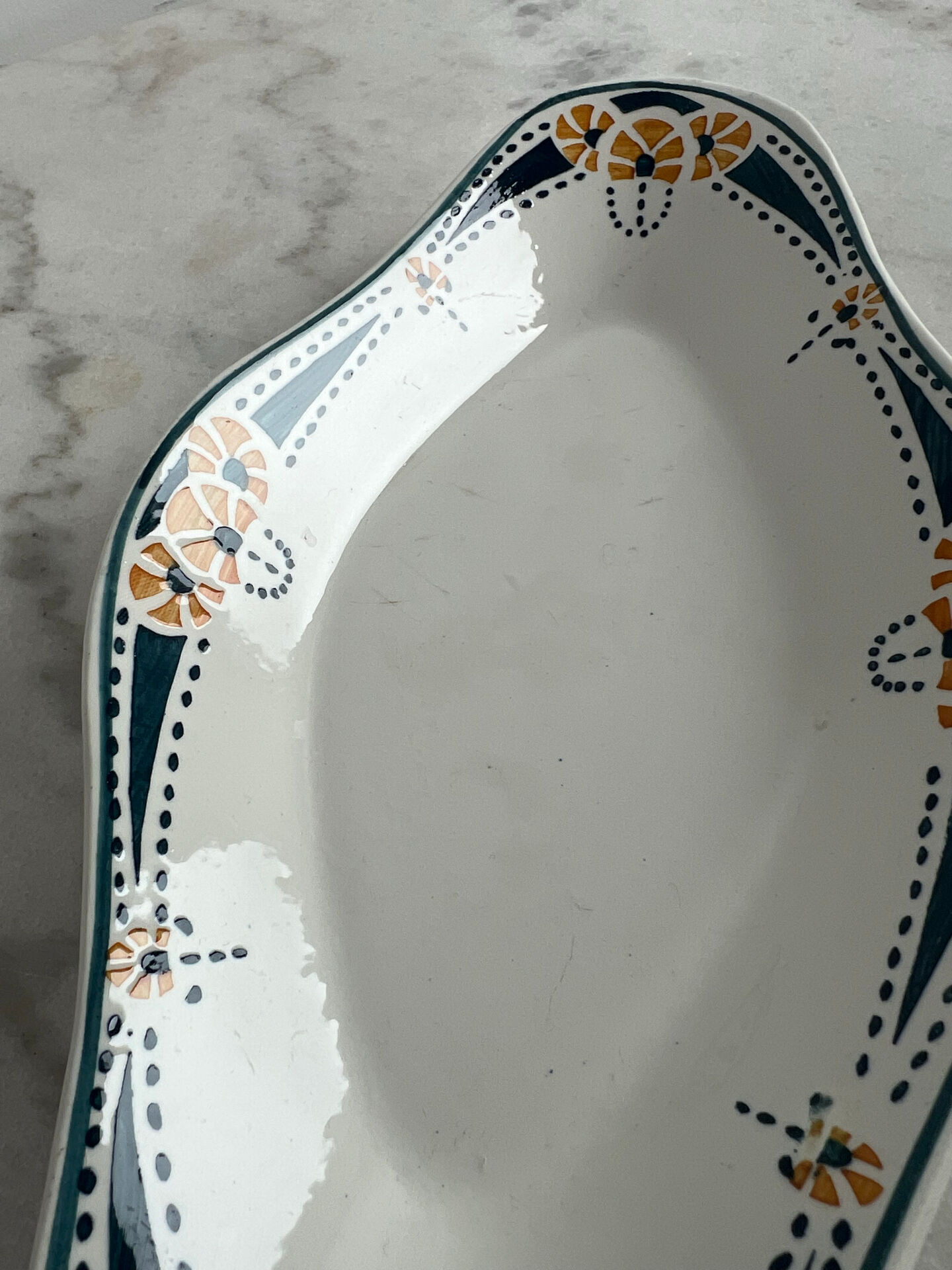 Longwy ramekin with blue and orange floral decoration.