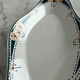 Longwy ramekin with blue and orange floral decoration.