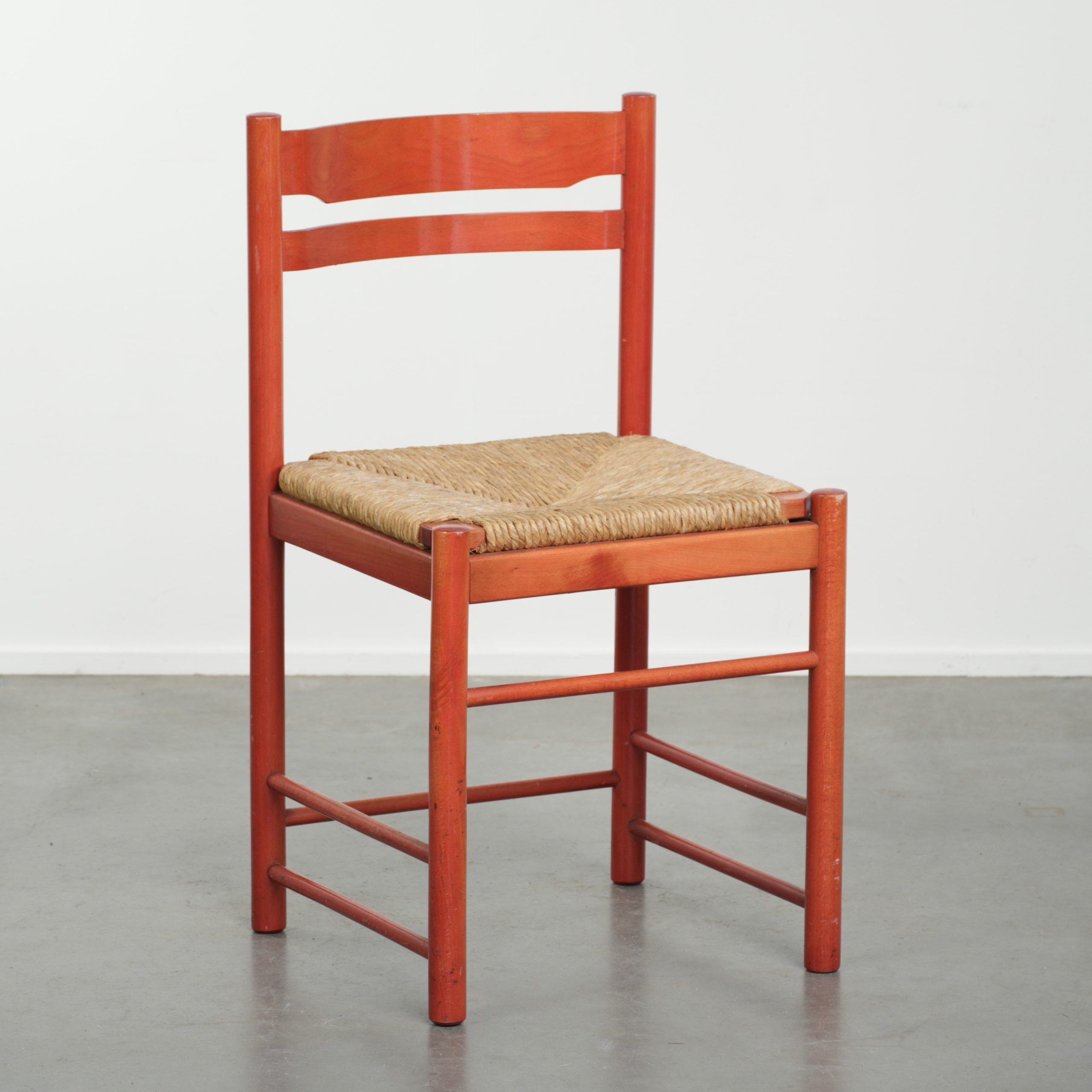 Nice red vintage wooden chair from the 1970s with a woven wicker seat