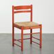 Nice red vintage wooden chair from the 1970s with a woven wicker seat